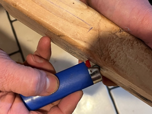 Holding the lighter at this angle and slowly rolling the scraping wheel allows a great deal of the pyrophoric metal dust to be collected.