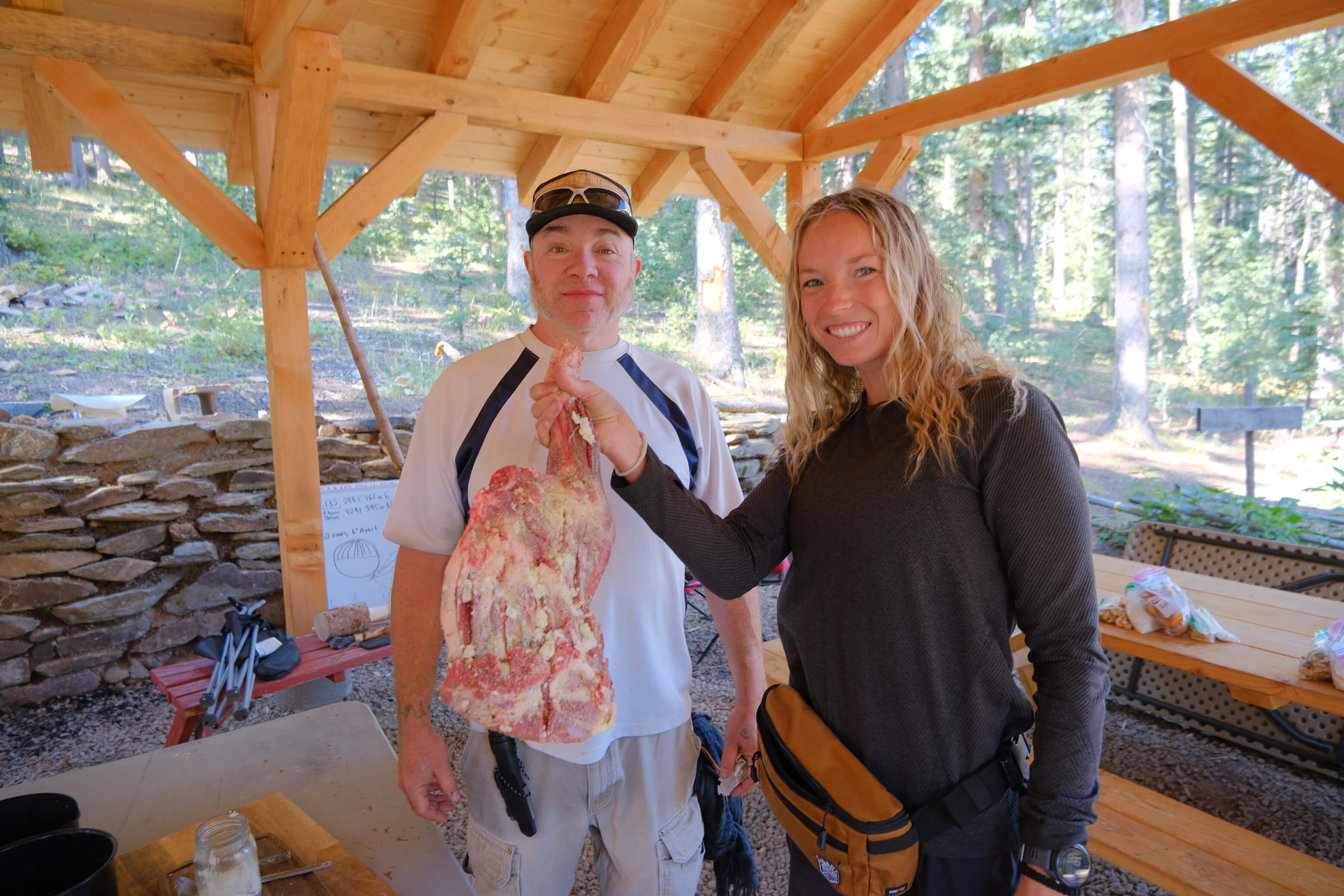 Participants holding harvested wild game during Field to Feast backcountry processing course