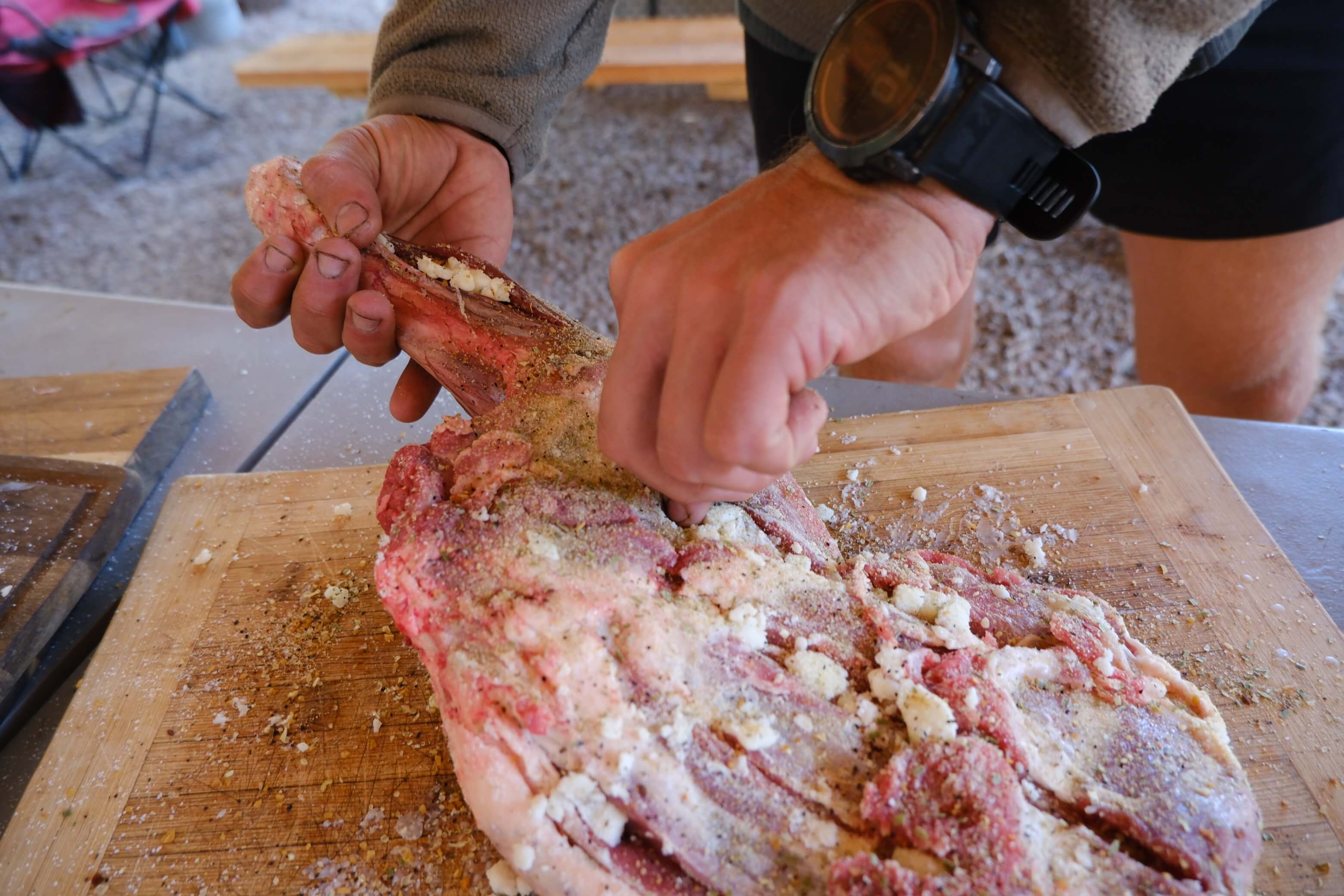 Close up of wild game being seasoned and prepared for cooking during Field to Feast wilderness training