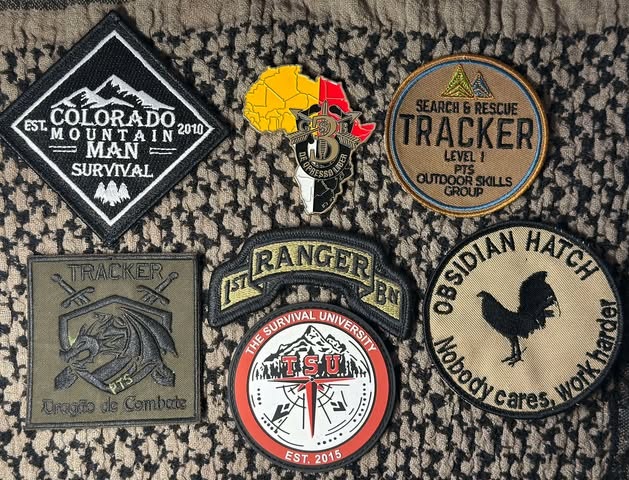 Jason Marsteiner – Recognition and Honors Patches Jason Marsteiner honorary military coins and survival training patches including 1st Ranger Battalion, TSU, and SAR tracking.