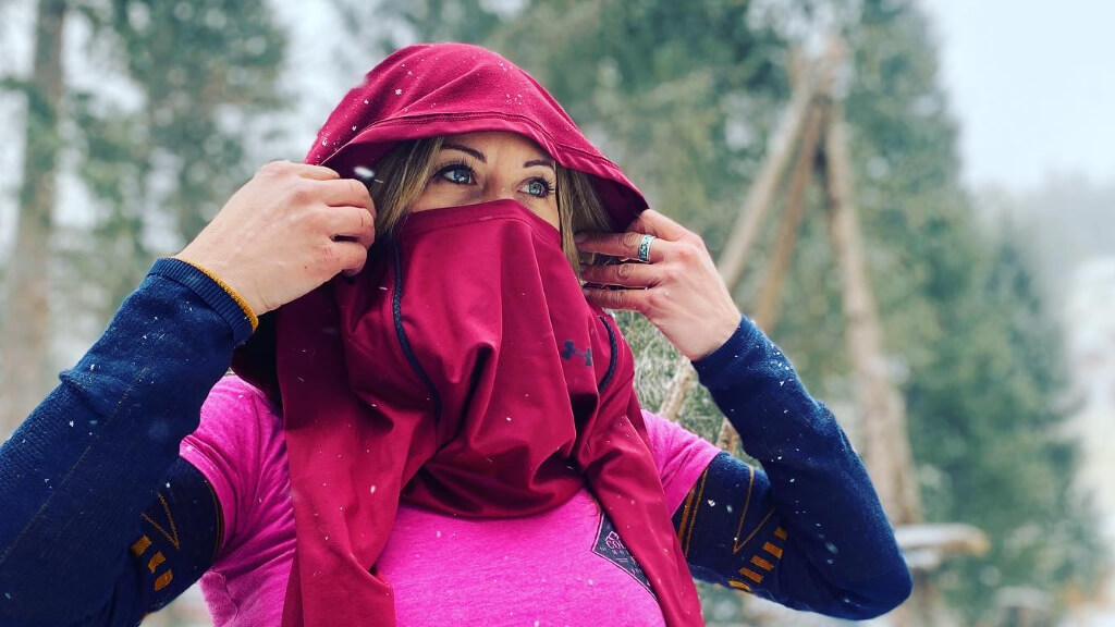 Jess Caldwell managing face and head coverage during winter training as snow falls, illustrating the body’s response to cold exposure