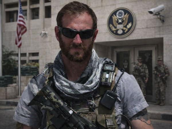 Chris Dahl, tactical instructor, standing outside a United States embassy style facility during a controlled civilian SERE training scenario.