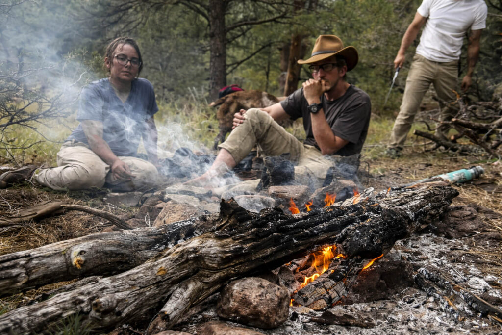 Students gathered around campfire during 50 day wilderness immersion leadership training program