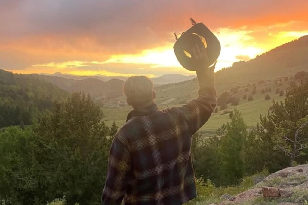 Instructor overlooking Colorado mountains at sunset during wilderness leadership training program